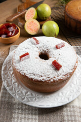 Brazilian corn cake made with a type of corn flour (Fuba) filled with guava paste. On a wooden party table. Typical sweets of the June festival. Cornmeal cake