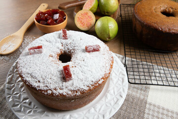Brazilian corn cake made with a type of corn flour (Fuba) filled with guava paste. On a wooden party table. Typical sweets of the June festival. Cornmeal cake