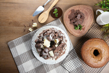 White chocolate and dark chocolate cake two loves on wooden table. Birthday and wedding cake. Top view
