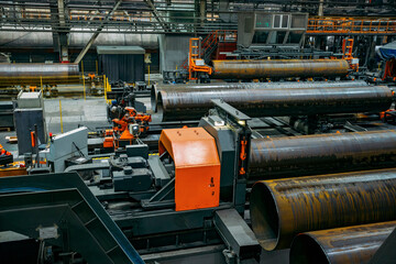Modern pipe factory production line. Pipe beveling machine
