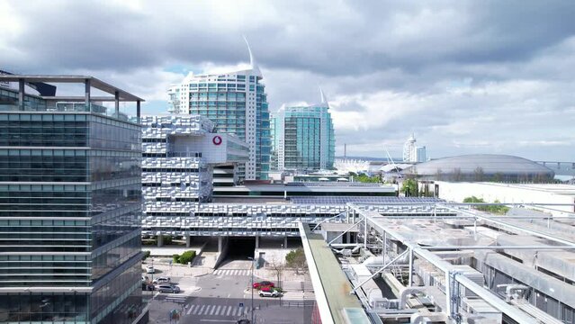 Lisbon, Portugal, April 24, 2022: DRONE AERIAL FOOTAGE: Casino Lisboa, Vodafone Portugal headquarters, and modern residential neighborhood with contemporary architecture seen from the Park of Nations.