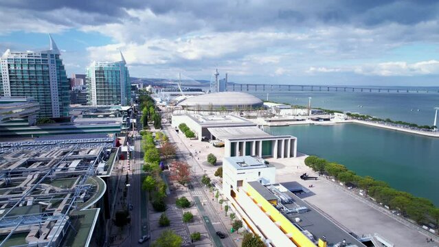 Lisbon, Portugal, April 24, 2022: DRONE AERIAL FOOTAGE: The Parque das Nacoes (Park of Nations), is a neighborhood in Lisbon constructed for the 1998 Lisbon World Exposition.