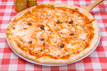 Pizza with salmon and Philadelphia cheese on plate on red italian table