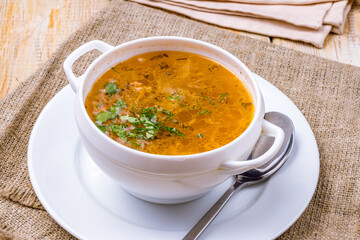 soup of sauerkraut on white bowl side view