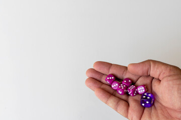 Holding dices in hand with a white isolated background
