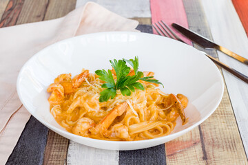 Pasta fettuccine with shrimps on white bowl