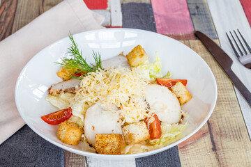 Salad caesar with chicken on white plate