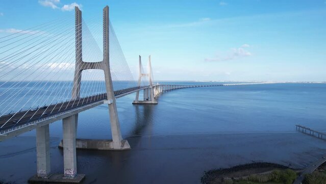 DRONE AERIAL FOOTAGE: The Vasco da Gama Bridge is a cable-stayed bridge located in the city of Lisbon in Portugal and crosses the Tagus River. It is the second-longest bridge in Europe.
