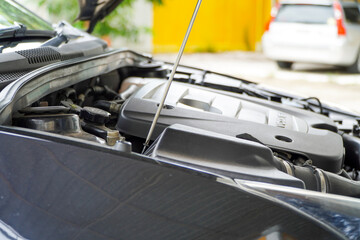 Mechanic removing the air filter cover of the car,maintenance concept