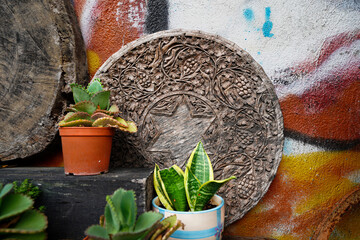 Detail of old wooden plate with colourful sprayed concrete as background. Aged traditional culture...