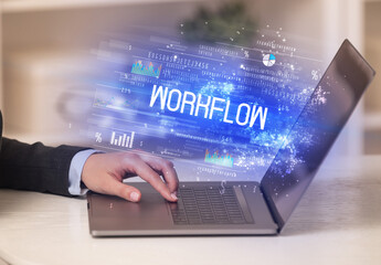 Closeup of businessman hands working on laptop