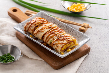 Delicious Taiwanese omelette, egg pancake roll with ham and corn kernels.