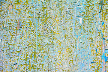 Cracked blue and yellow paints on old wooden wall. Abstract grunge vintage rustic texture. 