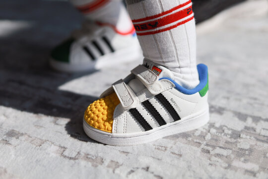 PENANG, MALAYSIA - 26 MAR 2022: Adidas Superstar Infants's Shoes Made In Partnership With Lego Brand. Adidas Is A German Corporation That Designs Footwear And Clothing.