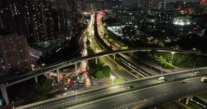 Aerial footage of night view buildings with interchange overpass in shenzhen city,China