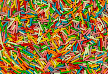 Fototapeta na wymiar Dots of sugar sprinkles, cake and pastry decoration, lots of sprinkles as a background