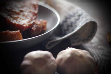 Fried Pork Belly with Fish Sauce Served on a Gray plate on a black wooden floor.