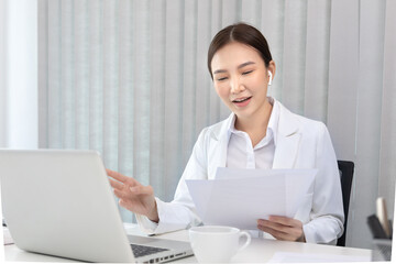 Young Asian women are talking friends and manager through video chats and greeting them with cheerful expressions, Online communication , Stay home, New normal, VDO Call, Internet working.