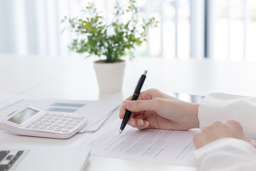 Financial businesswoman analyze the graph of the company's performance to create profits and growth, Market research reports and income statistics, Financial and Accounting concept.