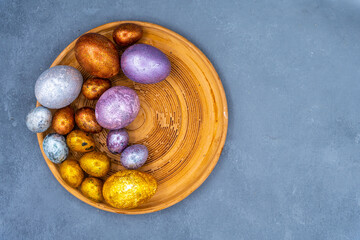 Easter background with golden and colored eggs. Happy easter background top view