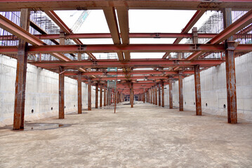 Reinforced steel frame structure under the construction building with steel piles screwed into the...