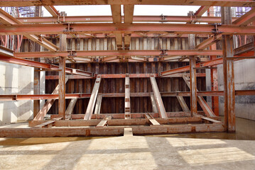 Reinforced steel frame structure under the construction building with steel piles screwed into the ground. Industrial concept.