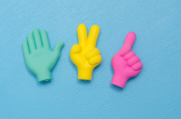 toy in the form of a hand with fingers on a blue background