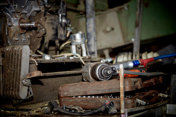 A professional mechanic works on a car engine in a garage. Car service.