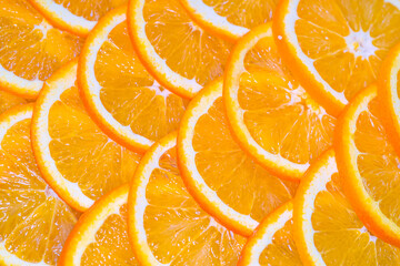 an orange cut into slices is lying on the table.