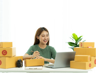 Starting small businesses SME owners female entrepreneurs check online orders to prepare to pack the boxes, sell to customers, sme business ideas online.