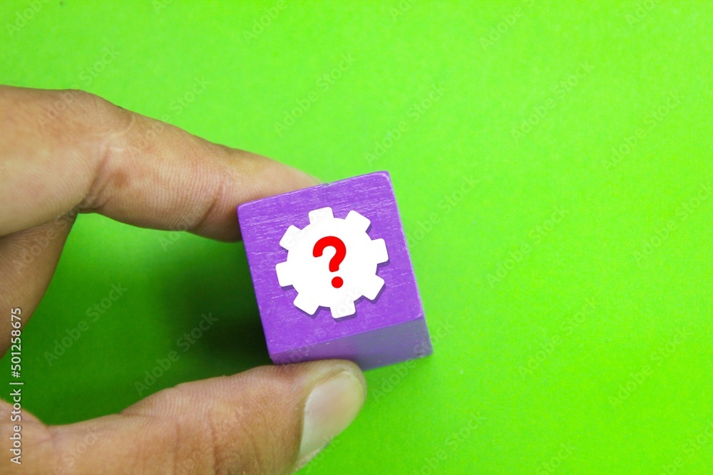 Aufkleber a hand holding a colored cube with a problem icon. the concept of finding a solution