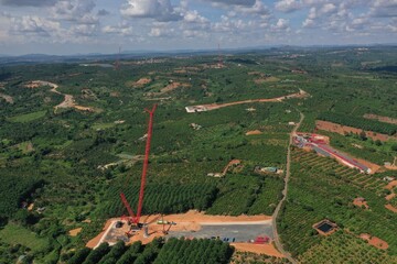 Landscape with construction site of wind turbine towers. Industrial concept for sustainable growth and reduce climate change and global warming