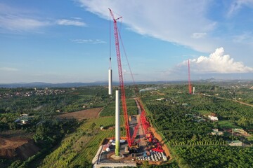 Fototapeta premium Landscape with construction site of wind turbine towers. Industrial concept for sustainable growth and reduce climate change and global warming