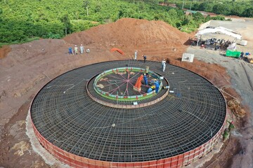 Aerial view at the construction site of the foundations of the wind turbines with concrete and...