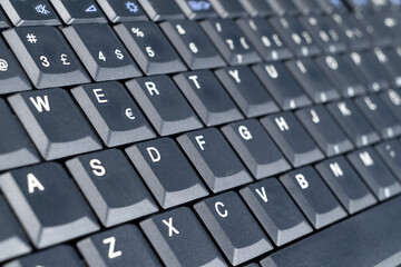 Closeup of a modern computer keyboard keys. Close up view of a business workplace with wireless computer keyboard. Top view