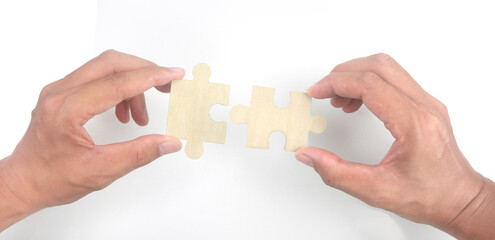 Connecting jigsaw puzzle in  hand