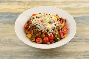 Fajita beef skillet skillet dinner with squash, tomatoes, peppers, and onions with shredded cheese