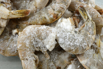 Freezer burned shrimp  in the shell coated with ice crystals from improper packaging or refrigeration