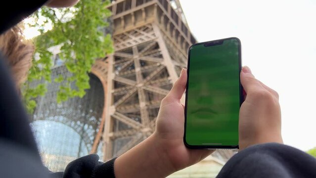 Teenage girl with loose hair brown hair brown hair dances with phone rejoices on the screen of lameness green screen beige background. High quality 4k footage