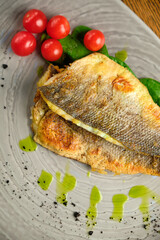 Fried fish fillet with tomatoes