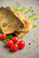 Fried fish fillet with tomatoes