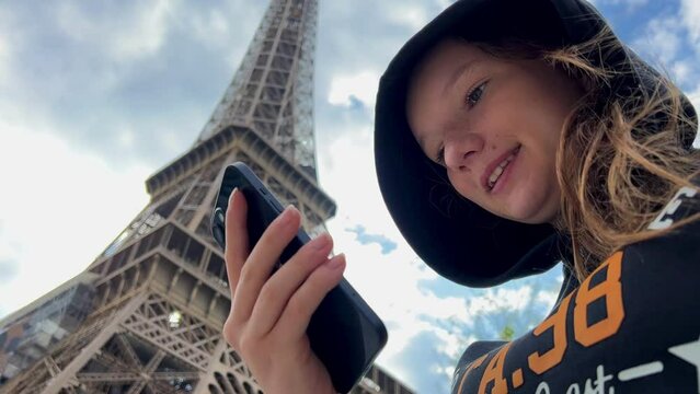 Advertising a tour to Paris, the travel agency can place its data on a green screen chromatey phone against the background of the eiffel tower. High quality 4k footage