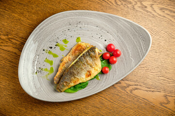 Fried fish fillet with tomatoes