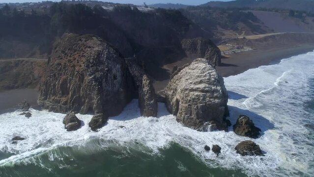 Waves Crashing Against On Rocas de Calabocillos, Dungeon Rocks In Constitucion, Chile. - aerial