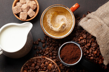 Fresh cappuccino and espresso coffee, roasted coffee beans, sugar and milk