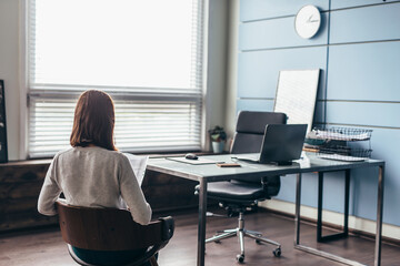 Woman waiting in an empty boss's office