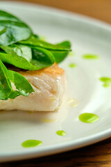 Pike perch fish fillet with spinach leaves