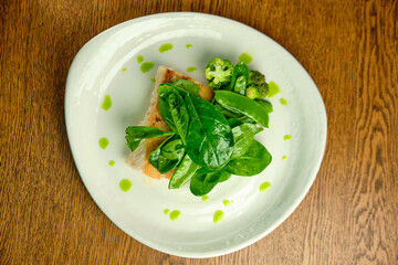 Pike perch fish fillet with spinach leaves