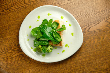 Pike perch fish fillet with spinach leaves