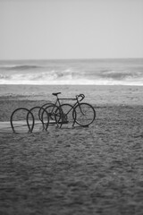 Obraz premium bike stands on the beach black and white photo